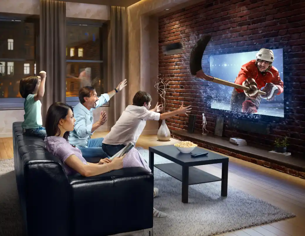 Happy family watching TV together at home with IPTV service in full HD